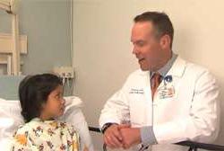 Doctor speaking to child patient bed side
