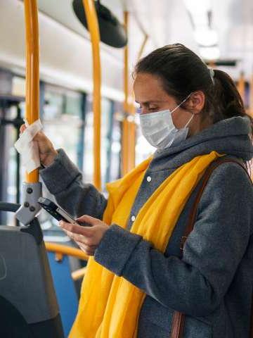 Woman on bus with mask on